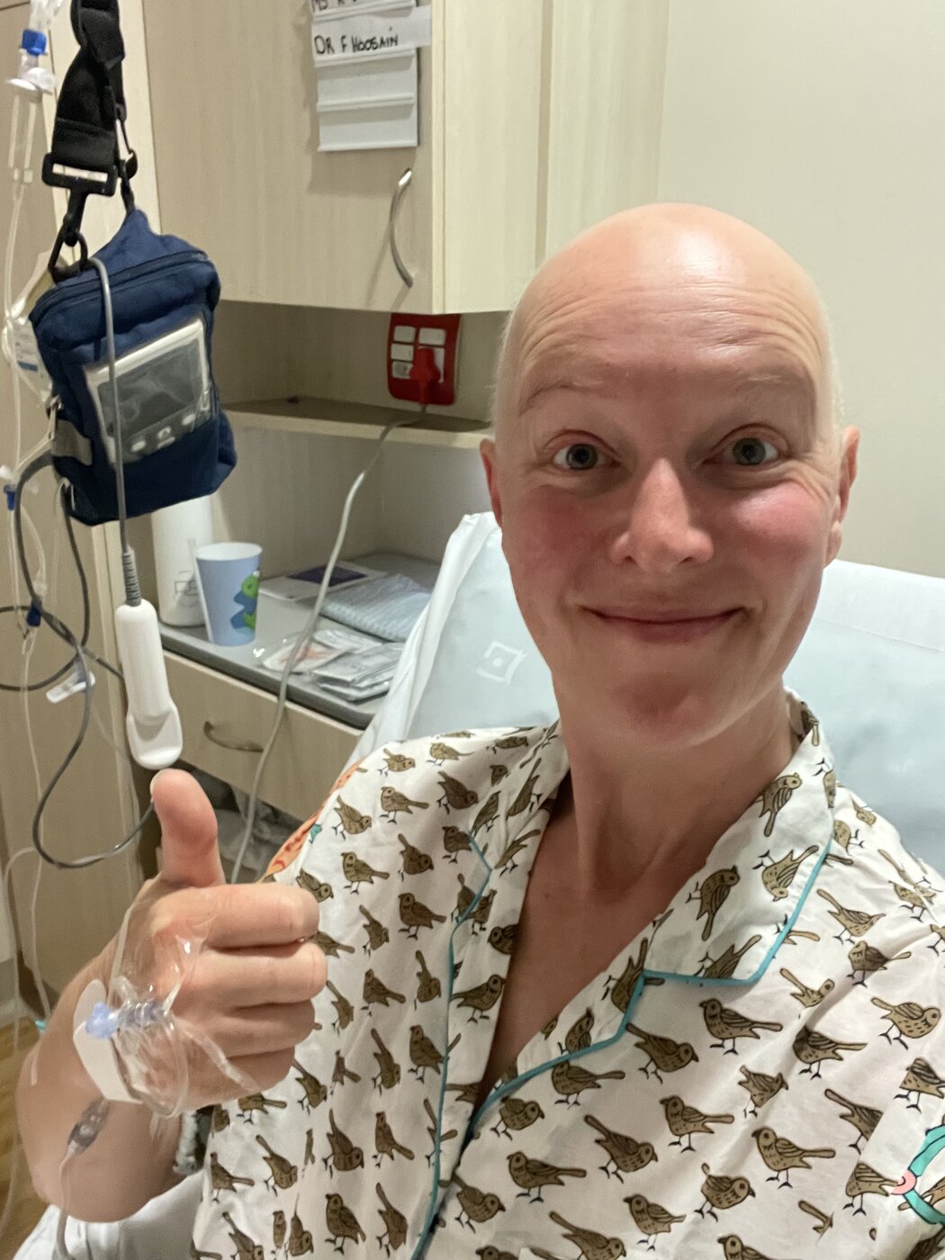 In the hospital bed, still smiling