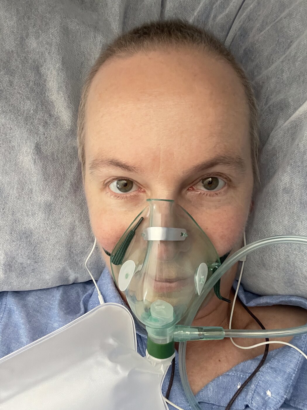 Breathing through an oxygen mask in hospital